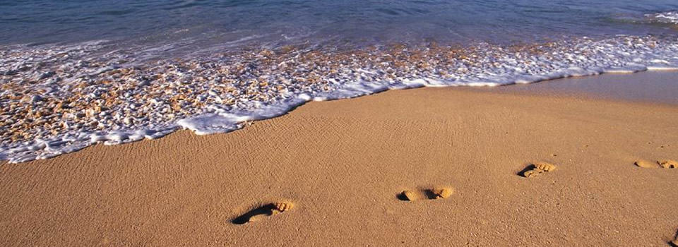 One set of footsteps on sand